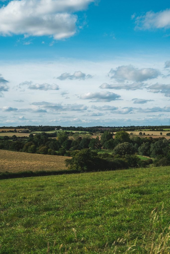 pexels-photo-2962775-2962775 Expansive countryside view with rolling fields and a vibrant sky.
